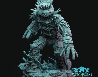 May include: A gray, detailed miniature of a creature made of wood and vines. The creature has a pumpkin head with a menacing expression and is standing on a circular base. The base has the text "WITCHSONG" on it.