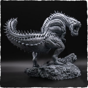May include: A detailed grayscale sculpture of a monstrous creature with a spiky tail and back, open jaws, and a textured body. The figure stands on a rocky base against a dark background, showcasing intricate details and a menacing pose.