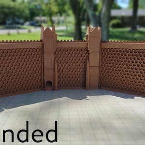 May include: A brown, modular, honeycomb-patterned wall with two towers, extended to its full length. The wall is made of plastic and has a textured surface. The text "Extended" is visible at the bottom of the image.