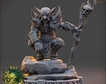 May include: A gray, detailed miniature of a goblin-like creature holding a staff with a skull at the top. The creature is wearing armor and is in a crouching pose. The miniature is on a gray base with a textured surface.