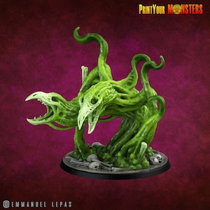 May include: A green monster figurine with a skeletal head and multiple tentacles. The figurine is on a round base with small skulls and bones. The text "PrintYourMonsters" is in the upper right corner.