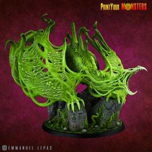 May include: A detailed, green monster figurine with a grotesque design. The creature has a gaping mouth, sharp claws, and a textured, organic appearance. The base features stone-like structures and the text "PrintYourMonsters".