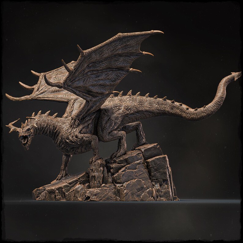 May include: A detailed bronze sculpture of a dragon with outstretched wings, perched on a rocky base. The dragon has a fierce expression and sharp claws.