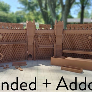 May include: A 3D printed castle wall set with towers and a honeycomb design. The set includes a variety of accessories, such as a mug, a small tray, and a long, thin box. The set is labeled "Extended + Addons".
