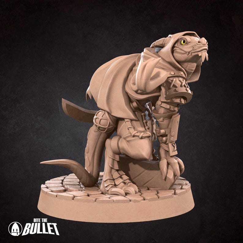 May include: A miniature figurine of a lizard-like creature wearing a hooded cloak and holding a sword. The figurine is painted in a light brown color and is standing on a circular base.