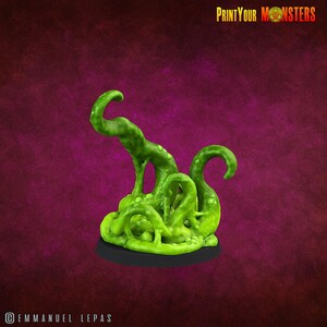 May include: A green, tentacled monster figurine with a textured surface, set on a black base. The tentacles curl upwards, and the figurine has a slimy appearance. The text "PrintYourMonsters" is visible in the top right corner.