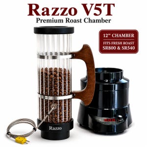 May include: Razzo V5T Premium Roast Chamber with a 12-inch glass cylinder filled with coffee beans, featuring a wooden handle, metal bands, and a temperature probe. It is shown next to a black base unit with a digital display and control knob.