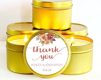 May include: Gold candle tins with a floral design and the text "Thank you Stacey & Johnathan 8.14.24" on the label.