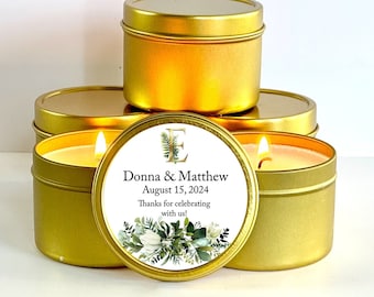 May include: Gold candle tins with a white label featuring a floral design and the text "Donna & Matthew August 15, 2024 Thanks for celebrating with us!"