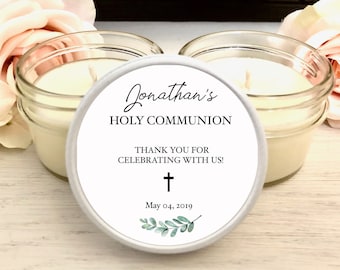 May include: Two small glass jar candles with white wax, each topped with a white lid. The lid features the text "Jonathan's HOLY COMMUNION" and "THANK YOU FOR CELEBRATING WITH US!" with a cross and date.