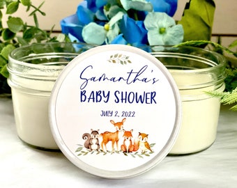 May include: White candle jar with a white lid featuring a round sticker with a blue and gold design. The sticker says "Samantha's Baby Shower" and "July 2, 2022". The sticker also features a watercolor illustration of a deer, two squirrels, and two foxes.