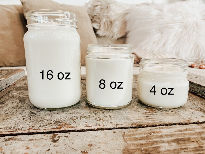 May include: Three glass candle jars with white wax. The jars are labeled with their size: 16 oz, 8 oz, and 4 oz.
