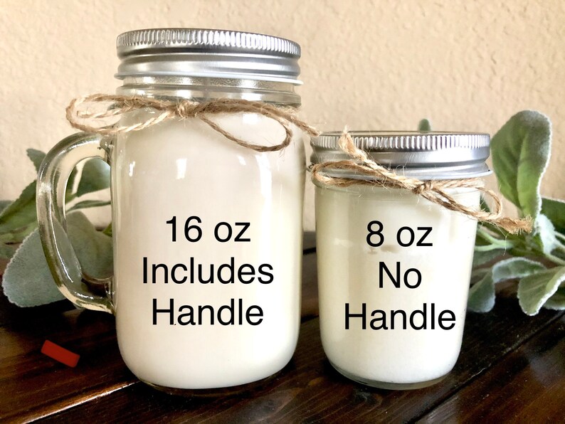May include: Two mason jar candles, one with a handle and one without. The larger candle is 16 oz and includes a handle. The smaller candle is 8 oz and does not have a handle.