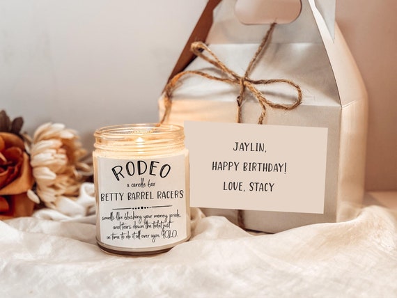 A handmade rustic soy candle with a punchy rodeo-themed humor twist — niche enough that any barrel racer will immediately feel seen.