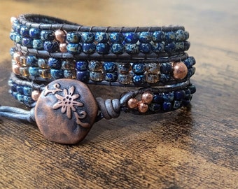 Boho Leather and Bead wrap bracelet made with blue Picasso seed beads and copper beads handsewn onto distressed blue leather cord.