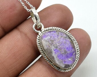 May include: A silver pendant with a purple and white gemstone. The pendant has a rope-like border and is attached to a silver chain.