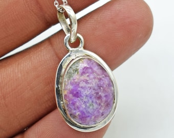 May include: A silver pendant with a purple and white oval gemstone. The pendant is on a silver chain.
