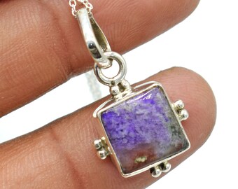 May include: A square pendant necklace with a purple and white gemstone set in a silver frame. The pendant is attached to a silver chain.
