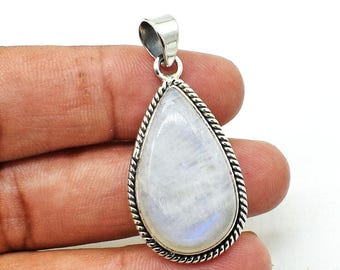 May include: A silver pendant with a white moonstone in a teardrop shape. The pendant has a rope-like border around the stone.