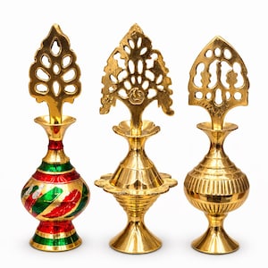 May include: Three ornate, gold-colored metal perfume bottles. The bottles have intricate designs, including floral and geometric patterns. One bottle features red and green painted accents. The bottles are displayed against a white background.