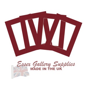 May include: Four red mat boards with white openings for framing photos or artwork. The mat boards are made in the UK.