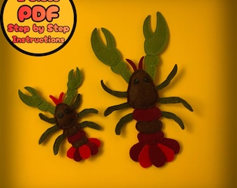 May include: Two felt lobster ornaments in shades of brown, red, and green sit on a yellow background. The lobsters have detailed claws, legs, and tail fins. A circular graphic in the upper left corner reads "2 Sizes PDF Step by Step Instructions."