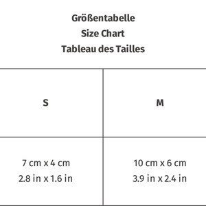 May include: Size chart table showing measurements in inches and centimeters for sizes S, M, and L. The measurements are for width and height.