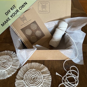 May include: DIY kit to make your own macrame spiral coasters. The kit includes a booklet with instructions and patterns, a ball of natural coloured string, and two finished coasters.
