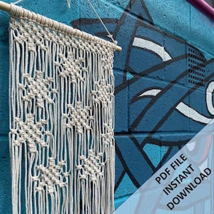 May include: A white macrame wall hanging with a geometric pattern, hanging on a blue brick wall with graffiti. The text "PDF FILE INSTANT DOWNLOAD" is in the bottom right corner of the image.