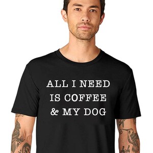May include: A black t-shirt with white text that reads "All I need is coffee & my dog".