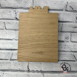 May include: A wooden clipboard with a blank surface. The clipboard has a decorative top with a cutout design.