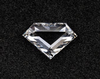 May include: A clear, faceted diamond with a brilliant cut, displayed against a black background. The gemstone's facets reflect light, creating a sparkling effect. The diamond's shape is a classic, symmetrical design, showcasing its clarity and brilliance.