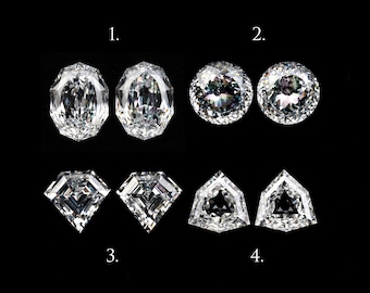 May include: A collection of four pairs of brilliant-cut diamonds, each with a unique shape. The diamonds are displayed against a black background. The shapes include oval, round, square, and shield cuts, showcasing their facets and brilliance.
