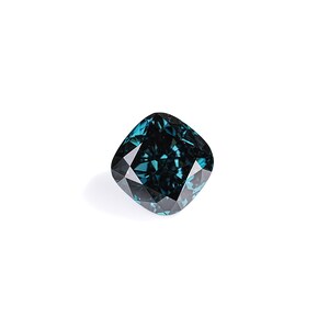 May include: A cushion-cut, teal-colored gemstone with a faceted surface. The gem is set against a white background, highlighting its deep color and intricate cuts. The gemstone's shape is square with rounded corners.