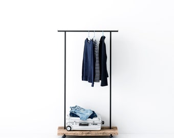 Small clothes rack made of reclaimed wood with practical wheels