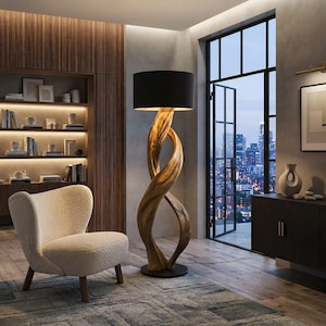 May include: A floor lamp featuring a twisted, natural wood base with a dark brown finish and a large, cylindrical black fabric lampshade. The lamp stands on a circular base, providing a vertical, sculptural element in the room's interior.