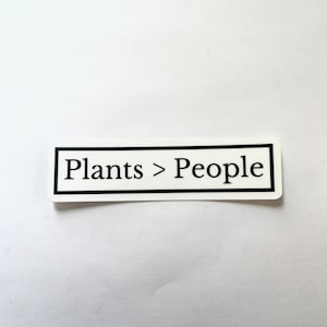 May include: White sticker with black border and text that reads "Plants > People".