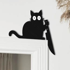 May include: A black cat silhouette holding a knife. The cat has large, white eyes and is perched on a white surface. The image has a minimalist design, suitable for Halloween or a quirky home decor theme.
