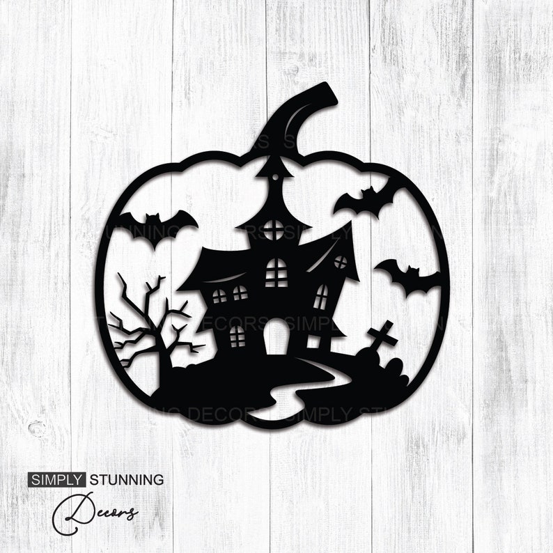 May include: Black metal Halloween pumpkin decoration featuring a haunted house, bats, a tree, and a graveyard scene. The decoration is cut out in a pumpkin shape with the words "SIMPLY STUNNING Decors" at the bottom.