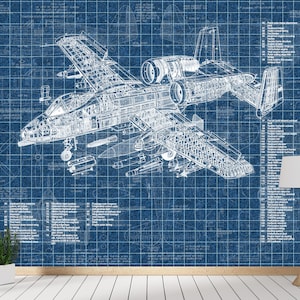 May include: A blue wall mural featuring a detailed white technical blueprint of an A-10 Thunderbolt II aircraft. The design includes extensive numbered parts lists on both sides of the central plane illustration, set against a grid background.