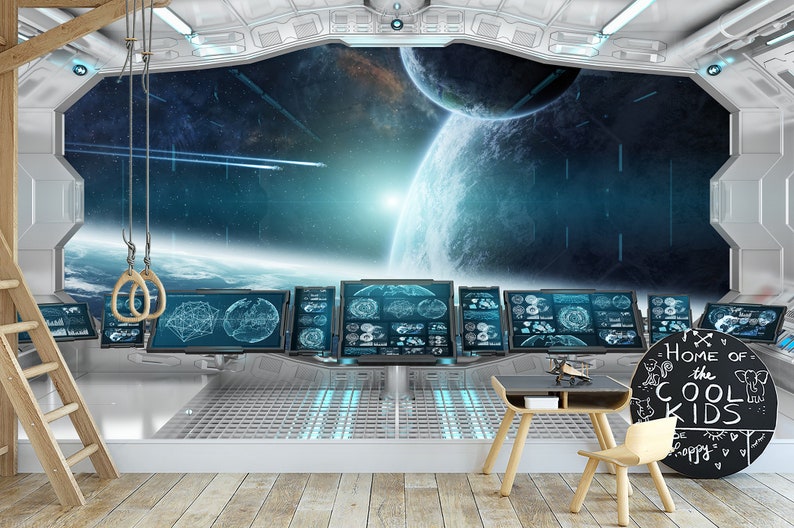 May include: A futuristic-themed room with a large window overlooking a space scene with planets and stars. The room features multiple computer screens, a small table, a chair, and a chalkboard sign that says "Home of the Cool Kids". Wooden gymnastic rings hang from the ceiling.