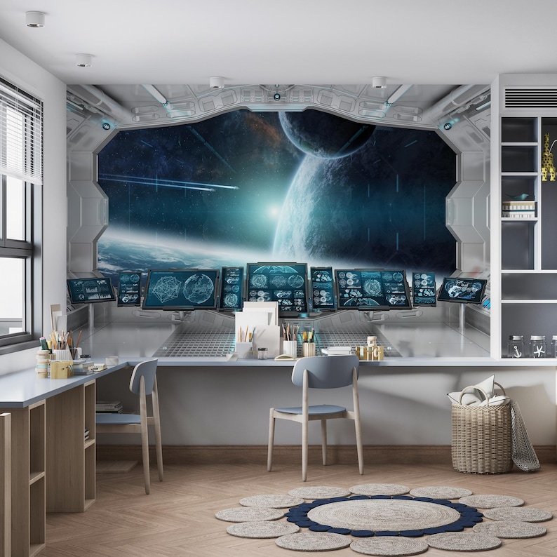May include: A room with a large mural depicting a spaceship interior with a view of planets and space. The room has a desk, chairs, and a round rug. The mural features blue and white planets, stars, and a bright light source.