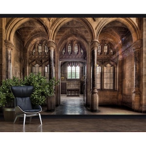 May include: A digital print of a gothic cathedral interior with arched ceilings, stone columns, and stained-glass windows. A modern black armchair sits in front of a large potted plant. The scene is bathed in warm light.