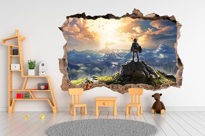 May include: A wall decal featuring a video game character standing on a mountaintop overlooking a vast landscape. The character is wearing a green tunic and holding a sword. The background is a sunset sky with clouds. The decal is designed to look like a hole in the wall, creating a 3D effect.