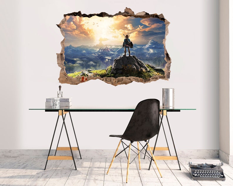 May include: A wall decal featuring a video game character standing on a mountaintop with a sunset in the background. The decal is designed to look like a hole in the wall, creating a 3D effect.