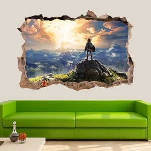 May include: A wall decal featuring a video game character standing on a cliff overlooking a vast, colorful landscape. The character is holding a sword and is looking out at the horizon. The decal is designed to look like a hole in the wall, creating a 3D effect.