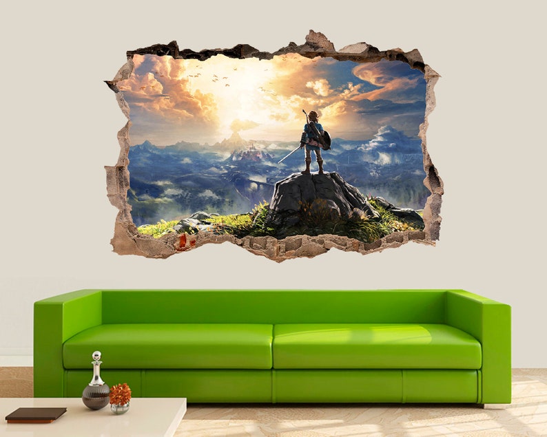 May include: A wall decal featuring a video game character standing on a cliff overlooking a vast, colorful landscape. The character is holding a sword and is looking out at the horizon. The decal is designed to look like a hole in the wall, creating a 3D effect.