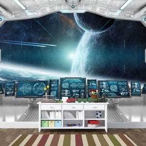 May include: A futuristic interior scene with a large window overlooking a space scene with planets and stars. A white cabinet holds toys, books, and a soccer ball. Multiple computer screens display data. The room has a metallic, modern design.