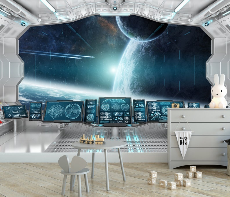 May include: A child's room with a space theme. The room features a large window with a view of planets and stars. There are computer screens, a small table, a chair, a dresser, and a bunny-shaped lamp. A banner reads "Dream Big".