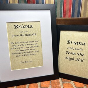 May include: Two framed prints with the name Briana and the text "Irish, Gaelic From The High Hill". The print on the left includes a Bible verse from Exodus 15:2.